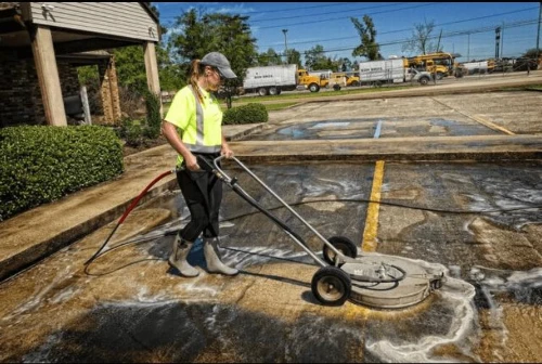 Stained commercial parking lot before pressure washing in Palm Coast, FL