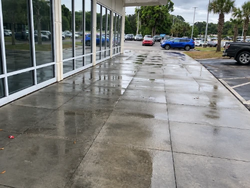 Dirty storefront exterior before commercial pressure washing in Palm Coast, FL